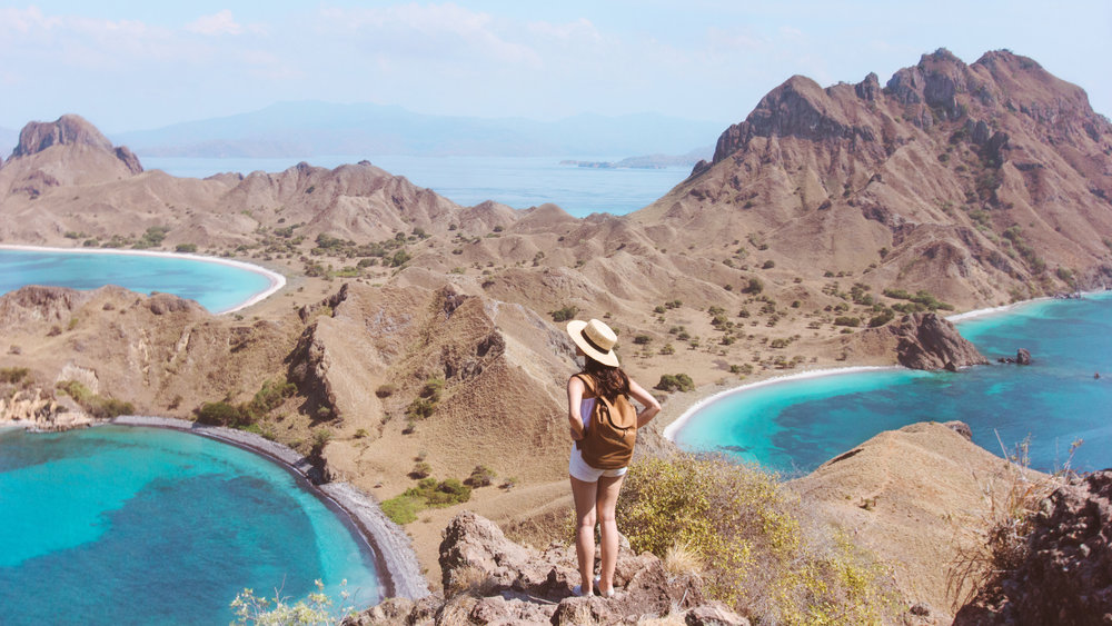 A woman enjoying Padar island panoramic view on the top | Hello flores