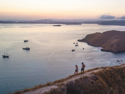 Tourists trekking the hills on an island 