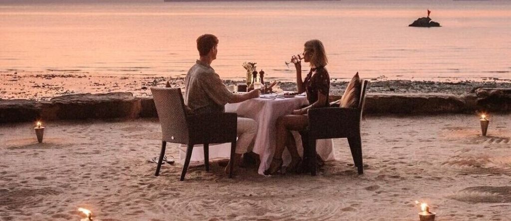 A couple is enjoying a romantic dinner on the evening