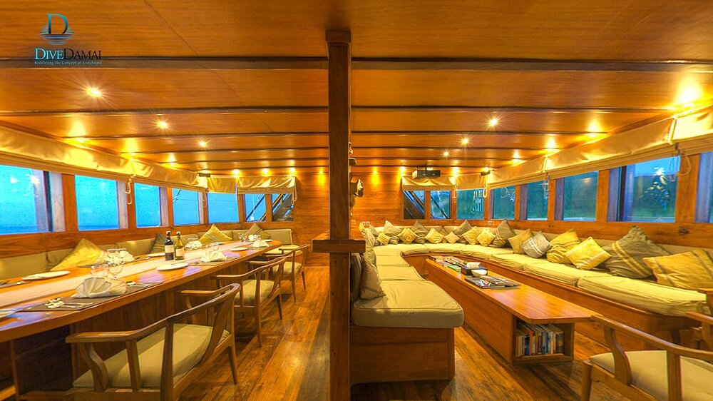 A giant lounge and dining area inside Damai II liveaboard | Hello Flores