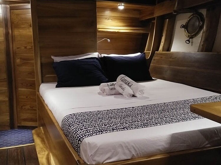 Main bedroom with comfortable double bed inside Tanaka liveaboard
