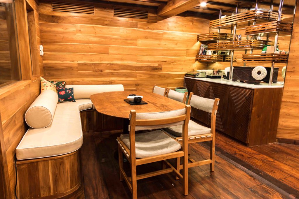 The indoor dining room in Magia 2 liveaboard | Hello Flores